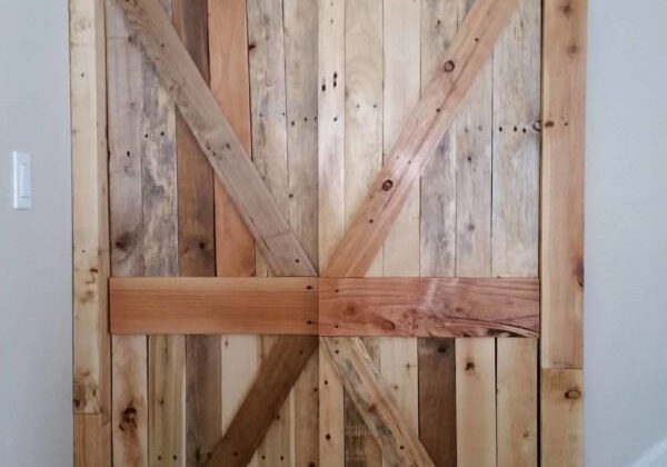These Pallet Closet Doors are rustic, stylish, and make a dull hallway look extraordinary. Add a custom punched-metal piece on the top and you've got a one-of-a-kind creation that'll set your house apart!