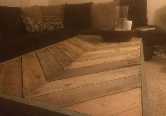 A beautiful reclaimed pallet wood table built in a chevron pattern
